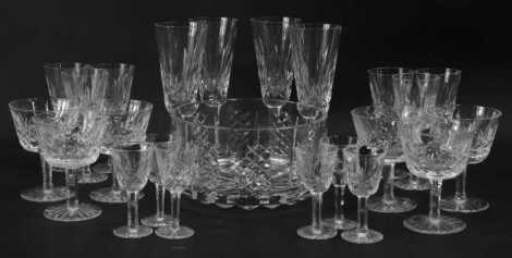 A part suite of Waterford Crystal Lismore pattern glasses, comprising four champagne flutes, six sherry glasses, six cocktail glasses, six liqueur glasses, and a salad bowl.