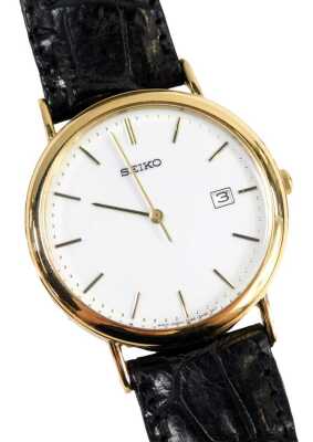 A Seiko gent's wristwatch, with white enamel dial, in a 9ct gold case, engraved MJF Service 1976-1997 Spirax-Sarco Limited, serial number 380803, 9ct gold with import marks, on a black leather strap, the dial 3cm wide.