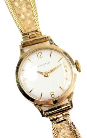 A Certina 9ct gold lady's wristwatch, the small silvered dial with numbered border, on a bark effect design bracelet, with double rope twist border, 18.3g all in, in a Certina box.