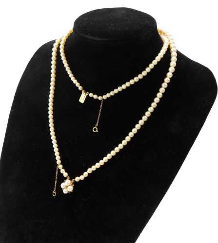 A two strand cultured pearl necklace, the clasp cluster set with a ruby and pearls, 40cm long.