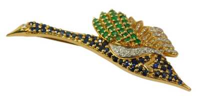 An 18ct gold bird brooch, set with sapphires, emeralds and diamonds, 6.5cm diameter, 11.9g. The weight is 11.9g.