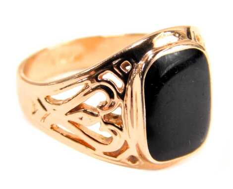 A gentleman's signet ring, set with a polished rectangular cut black onyx, in a rub over setting, with pierced design shoulders, stamped 18ct GF, gold plated, size W½.