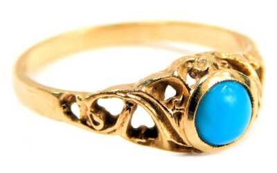 A 9ct gold and turquoise dress ring, the circular turquoise in a rub over setting, with pierced scroll design shoulders, ring size Q, 2.4g all in.