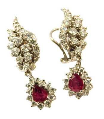 A pair of ruby, diamond and white gold earrings, set with an arrangement of pear cut rubies and diamond spray ferns, stamped 18ct, 17g all in.