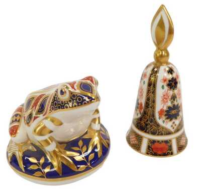 A Royal Crown Derby porcelain paperweight modelled as a frog, gold stopper and red printed marks, 8cm high, together with a Royal Crown Derby porcelain bell decorated in the Imari pattern, 1128, red printed marks, 13cm high.