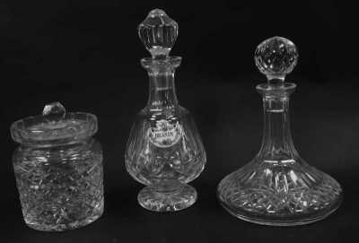 A group of Waterford Lismore pattern glassware, comprising ship's decanter and stopper, 26cm high, cylindrical biscuit barrel and cover, 18cm high, and a further decanter and stopper, 30cm high. (3)