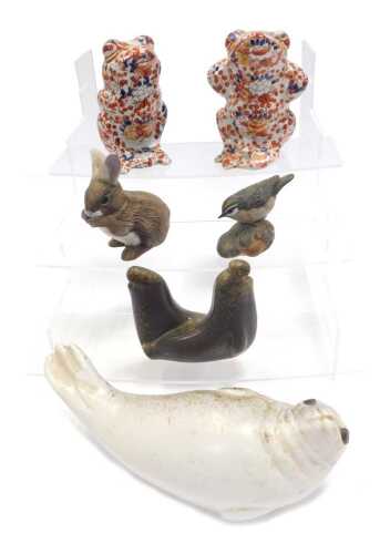 A Swedish pottery model of a reclining seal, 23cm wide, a Poole pottery bird on a leaf, 8cm high, and two Oriental style Imari pattern frogs, 17cm high, etc. (a quantity)