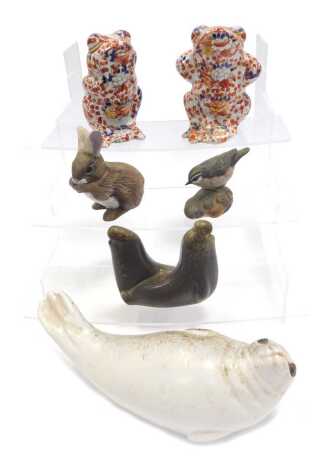 A Swedish pottery model of a reclining seal, 23cm wide, a Poole pottery bird on a leaf, 8cm high, and two Oriental style Imari pattern frogs, 17cm high, etc. (a quantity)