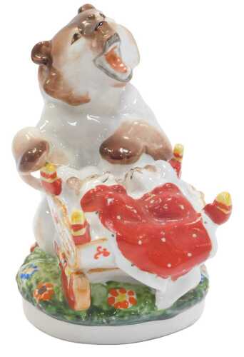 A Lomonosov porcelain figure group modelled as two baby bears in a crib beside a mother bear, indistinct printed mark, 18cm high.