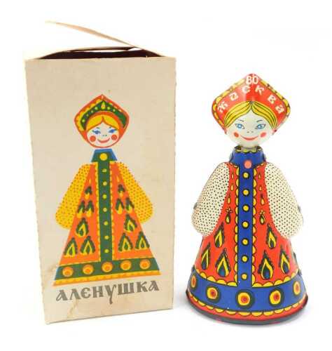 A tinplate windup figure modelled as a lady in provincial Russian dress, 15cm high, boxed with key.