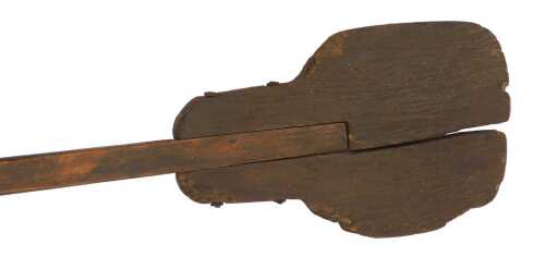 A wooden bread paddle, labelled as used at Beltons Bakery, Church Street , Market Deeping, which closed in 1973, 236cm long.