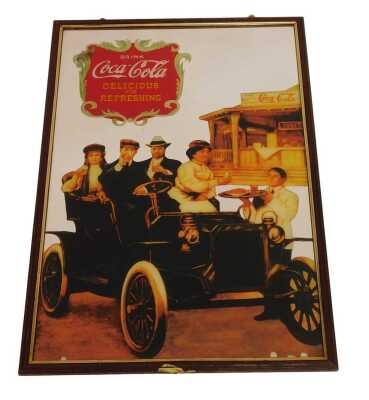 A reproduction Coca-Cola advertising mirror, depicting figures drinking Coca-Cola in an automobile, 82cm x 53cm.