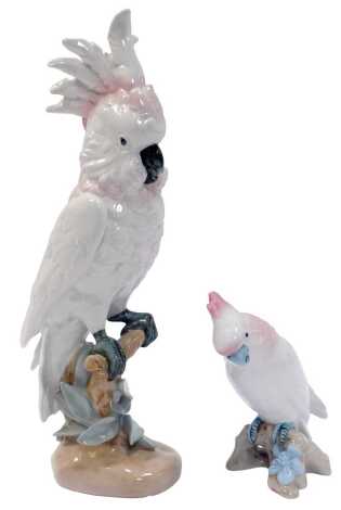 A Royal Dux porcelain figure modelled as a cockatoo, printed marks, 44cm high, and a further smaller example, 18cm high.