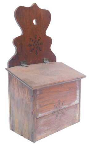 An early 20thC oak candle box, with stencilled decoration, 38cm high. (AF)