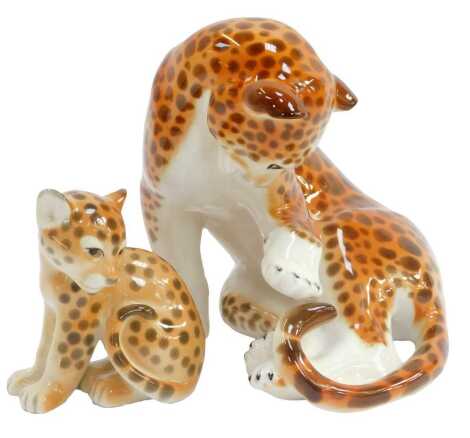 A Lomonosov porcelain figure modelled as a seated cheetah, 17cm high, and cub, 10.5cm high, each with red printed marks.