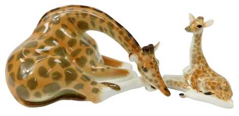 A Lomonosov porcelain figure modelled as a seated giraffe, 12cm high, and calf, 13.5cm high.