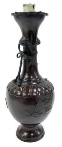 A Qing Dynasty late 19thC vase, of bottle form, with twin dog of fo head handles, with bow held in the mouth, one missing, decorated in relief with swallows on circular foot, four character seal mark, converted to a table lamp, 38cm high.