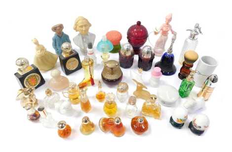 A group of Avon perfume bottles, some with contents. to include ET wearing a jacket, 15cm high, owl, a figure of a lady with dove on her palm, etc. (1 tray)