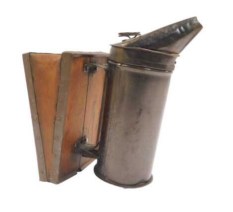 A Victorian bee smoker, mounted on a set of pine and leather bellows, 21cm high.