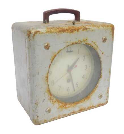 A Smiths pigeon clock, the circular dial bearing Arabic numerals, thirty hour, in a grey painted metal case with handle, 28cm high overall.