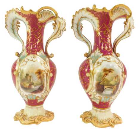 A pair of early 19thC Coalport porcelain twin handled vases, each decorated with a reserve depicting buildings, against a white and a maroon coloured ground, gilt heightened, numbered to underside, 25cm high.