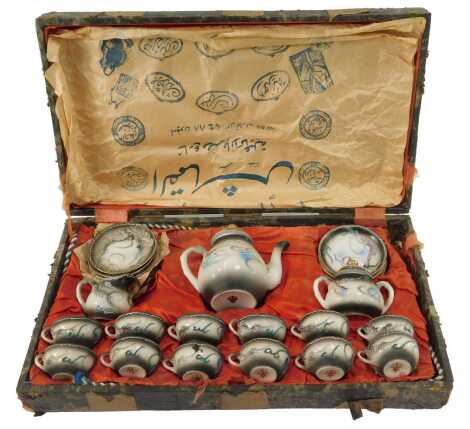 A Japanese eggshell porcelain coffee service, comprising a coffee pot, twelve cups and saucers, sucrier and cream jug, cased, 46.5cm wide.