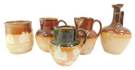 A group of Royal Doulton stoneware, to include a biscuit barrel lacking lid, 14cm high, three jugs, 17cm high (2), and 15cm high, and a Doulton Lambeth jug, 25cm high. (AF)