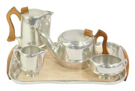 A Picquot ware stainless steel tea service, comprising teapot, hot water jug, sugar bowl, milk jug and tray.