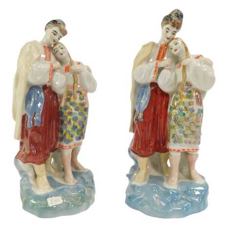 Two USSR porcelain figure groups depicting a male and female embracing, printed marks, 28cm high.