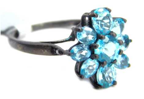 An apatite and diamond set cluster ring, on a blackened white metal band, stamped 925, ring size N½, 2.5g all in, boxed.