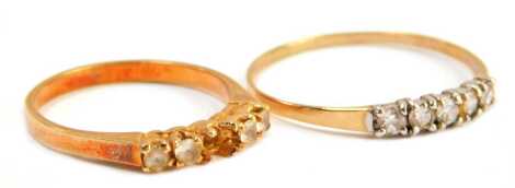 Two dress rings, comprising a 9ct gold and cz set five stone dress ring, size V, 1g all in, and a costume ring. (2)