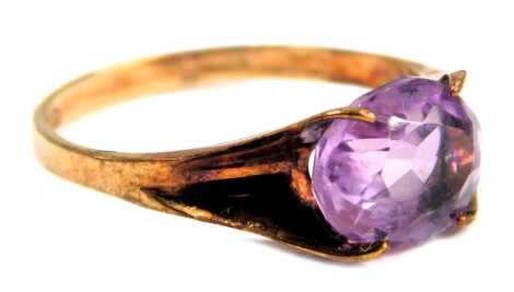 An amethyst dress ring, set with an oval amethyst, in a shaped four claw setting, with pierced and flowing shoulders, yellow metal, stamped 375, ring size P, 2.1g all in.