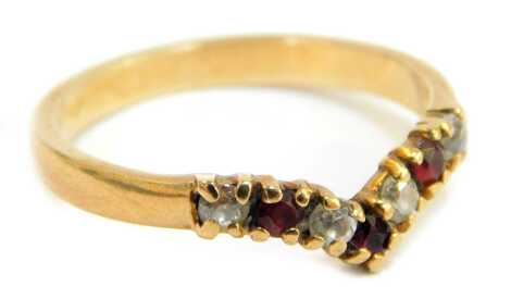 A 9ct gold wishbone ring, set with garnets and CZs, in a claw setting, ring size O½, 2.3g all in.