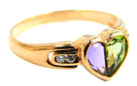 A 9ct gold dress ring, the central heart shape set with amethyst and peridot, with tiny diamond set shoulders, ring size O, 2.1g all in, boxed.