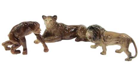 Three items of Melba ware pottery, comprising a chimpanzee, 16cm high, lion, 14cm high, and lioness, 16cm high.