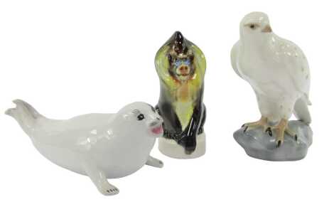 A Russian porcelain figure modelled as an Icelandic Falcon, 21cm high, together with a Lomonosov porcelain seal and a baboon. (3)