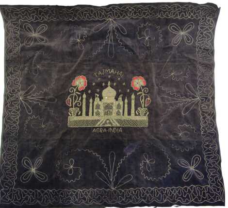 An early 20thC Indian silver embroidered panel, depicting the Taj Mahal in Agra India, on a dark blue velvet backing, 84cm x 90cm.