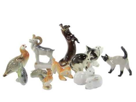 A group of Lomonosov and other Russian porcelain animal figures, to include a black and white kitten, 13cm high, Siamese cat, 13cm high, otter and fish, 22cm high, ibis, 17cm high, etc. (1 tray)