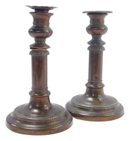 A pair of early 20thC copper candlesticks, with gadrooned decoration, bearing indistinct crown and GR initials, 20cm high.