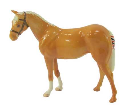 A Beswick pottery model of a palomino horse, printed marks, 16.5cm high.