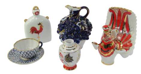 A group of Lomonosov and other Russian porcelain, to include a decanter and stopper modelled as a peacock, 19cm high, a jug, relief moulded with grapes and vines, in cobalt blue with gilt highlights, 20cm high, etc. (a quantity)