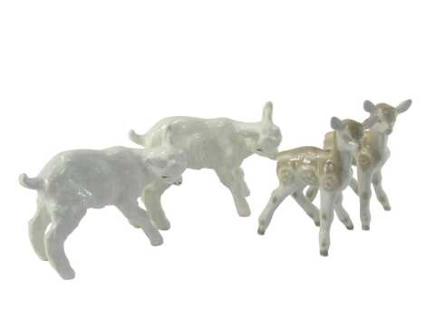 Two Russian porcelain figures, each modelled as a lamb, 17cm high, together with two further examples, 20cm high.