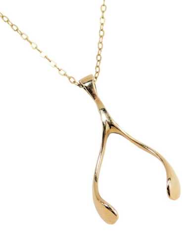 A 9ct gold wishbone pendant and chain, the pendant 3.5cm high, on a fine link neck chain, 44cm long, 6.2g, boxed.