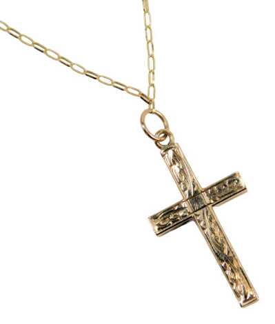 A 9ct gold crucifix pendant and chain, the crucifix pendant of scroll decoration, on a fine box link neck chain, 54cm long, 2.4g.