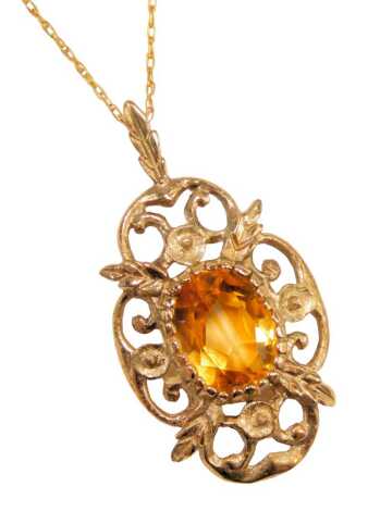 A citrine set pendant and chain, the oval floral pendant, 2.5cm high, on a fine link neck chain, 46cm long, 2.4g all in.