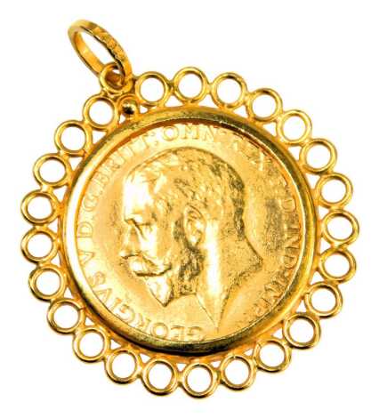 A George V half gold sovereign pendant, dated 1918, in pierced border, yellow metal stamped K18, 5.6g.