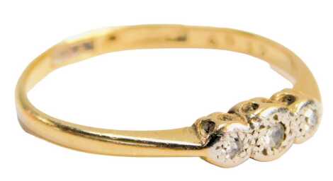 A 1930s diamond three stone dress ring, set with three illusion set diamonds in platinum, on a yellow metal band stamped 18ct plat, ring size S½, 2.7g all in.