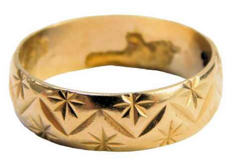 A 9ct gold wedding band, of patterned star design, with inner inscription, ring size N½, 2.9g.