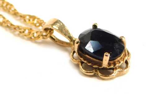 A 9ct gold and sapphire single stone pendant, on a fine curb link neck chain, with bolt ring clasp, 2.9g.