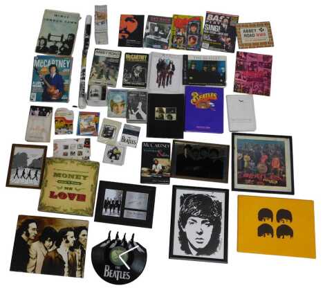 A group of Beatles ephemera, to include record wall clock, Beatles Yellow Submarine diecast Hot Wheels vehicle, various books, mugs, badges, canvas prints, etc. (a quantity)